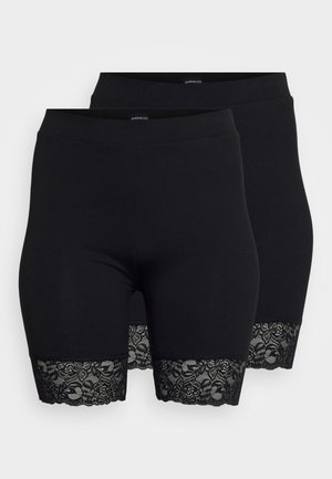 Pantaloni ciclistici neri con bordino in pizzo all'orlo. Realizzati in tessuto elastico e liscio. Presentano una vita alta per una vestibilità comoda.