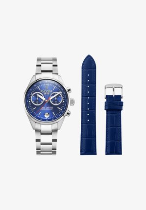 Zegarek chronograf Roamer 1888 ze stali nierdzewnej z niebieską tarczą, czerwoną wskazówką sekundową oraz dwoma dodatkowymi niebieskimi skórzanymi paskami z srebrną klamrą.