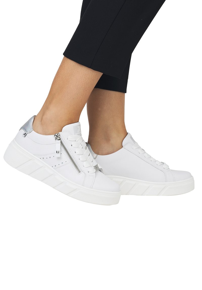 Baskets blanches avec une semelle texturée, dotées d'une fermeture éclair latérale, d'un design à lacets et d'une tige en synthétique lisse. Soulignées de détails en argent.
