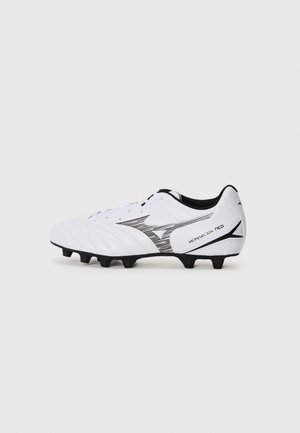 White soccer cleat with black accents, featuring a textured upper, curved design, and six black studs on the bottom for traction.