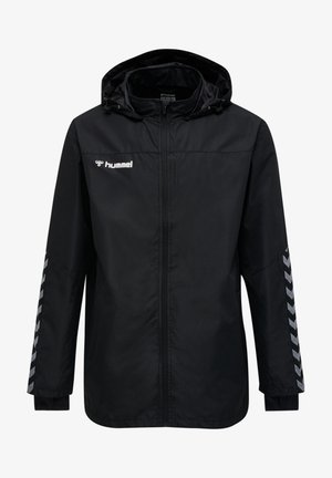 Veste légère noire avec capuche, dotée d'une fermeture éclair intégrale, d'un motif en chevrons réfléchissant sur les manches et d'une texture subtile. Logo Hummel sur la poitrine.