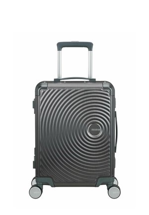 Valise trolley rigide gris foncé avec motif de cercles concentriques, quatre roues, poignée rétractable et poignée latérale.