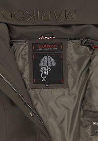 Brown jacket interior with a smooth texture. Features a black label with a red border, depicting a character holding an umbrella.