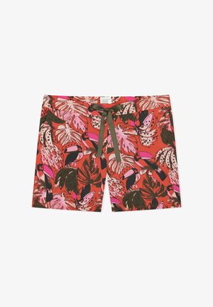 Red shorts with pink and green tropical leaf and toucan bird print, featuring a dark green tie string at the waist.