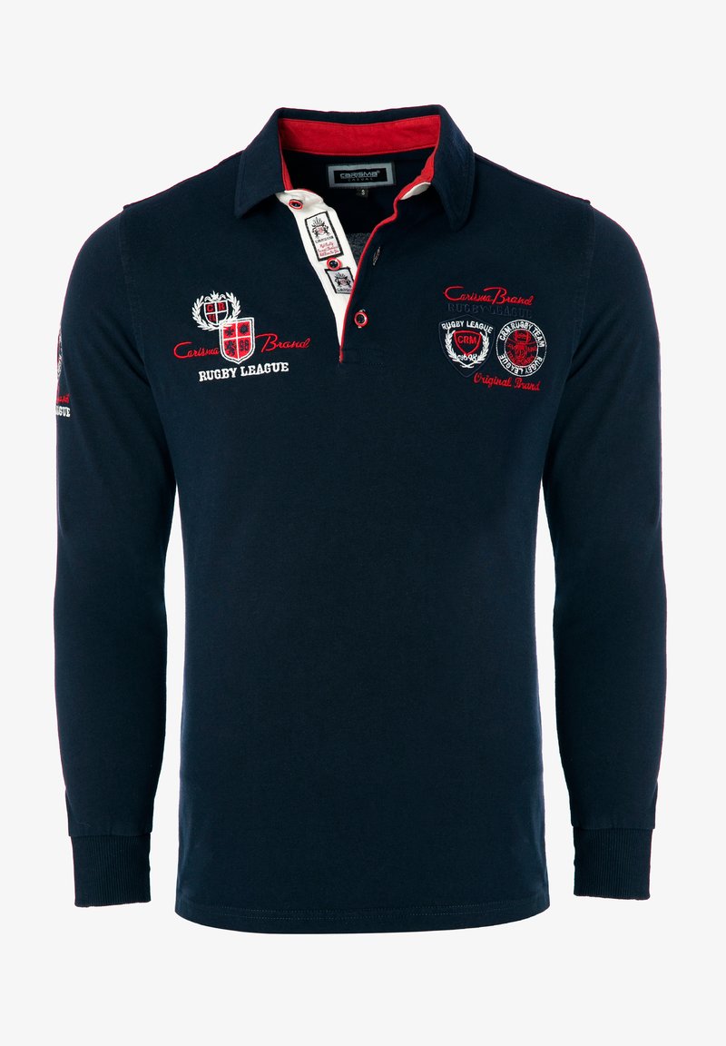 Mornarsko modra rugby polo majica z dolgimi rokavi in rdečimi poudarki, z gumbi na sprednji strani, izvezenimi logotipi in rebrastimi manšetami. Bombažna tkanina zagotavlja udobje.