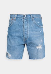 Light blue denim shorts with a high waist, featuring distressed elements and frayed hems. Classic five-pocket design with metal button closure.