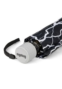 Compact black umbrella featuring a lightning bolt pattern, rubberized white handle with logo, and a secure closure strap.