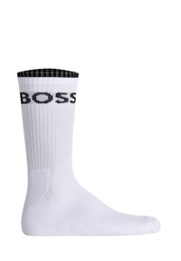 White sock with ribbed texture, black top band, and prominent "BOSS" logo in black. Standard length, smooth material, and seamless toe design.