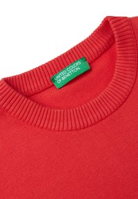 Suéter de algodón rojo con cuello redondo acanalado y una etiqueta verde bordada que dice "United Colors of Benetton". Textura suave.