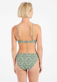 Žalias raštuotas bikini, turintis plonas reguliuojamas petnešas ir užsegimą nugaros. Apatinė dalis pasižymi suderinta geometrine struktūra.