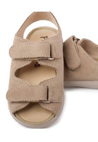 Beige suede sandals with two adjustable Velcro straps, cutout design, and a cushioned insole; rubber outsole for traction and durability.