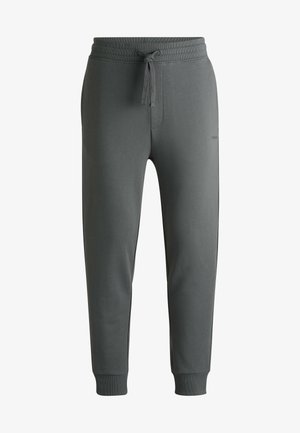 Gray sweatpants with a drawstring waist, tapered legs, and ribbed cuffs. Soft, smooth fabric with subtle branding on the side.