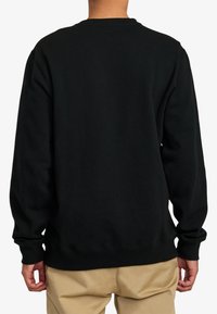 Sweatshirt noir avec une finition texturée, des poignets et une ceinture côtelés, présentant un col rond et une coupe décontractée, vu de dos.
