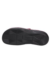 Black rubber outsole with multi-directional tread patterns and embossed branding. Side stitching visible along the edge. Flat design.