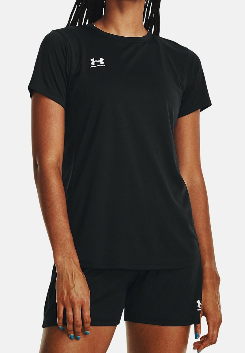 Black athletic shirt and shorts made of a smooth, lightweight fabric, featuring a small white Under Armour logo on the chest and leg.