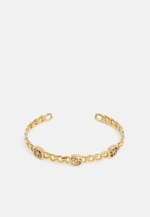 Bracelet chaîne en or ouvert avec trois maillons décoratifs ronds présentant des motifs découpés complexes.