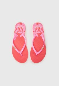 Røde flip-flops med rosa stropper, med et blomsterdesign på sålen og teksturerte såler for bedre grep. Gull-logo aksent på stroppen.