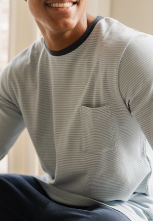 Light blue long-sleeve shirt with white stripes, black neckline, and a single chest pocket. Smooth fabric texture, relaxed fit.