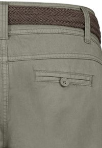 Light green trousers with a woven brown waistband, featuring a buttoned back pocket and clean lines, made from a smooth fabric.