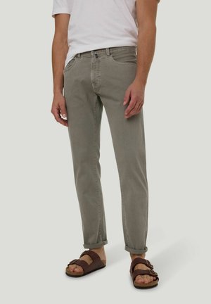 Light gray denim jeans with a straight leg, rolled cuffs, and a classic five-pocket design, paired with brown sandals and a white t-shirt.