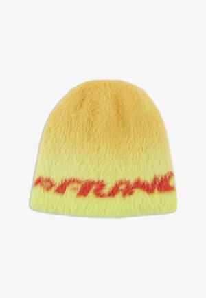 Puszysta żółta czapka typu beanie z pomarańczowym tekstem pisanym wokół dolnej krawędzi na białym tle.