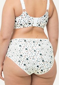 Witte beha en hooggesneden slip met een sterrenpatroon in zwart, roze en goud. Gemaakt van zachte stof met verstelbare banden.