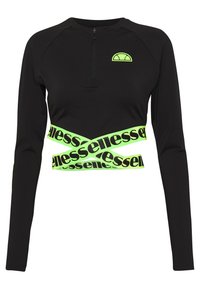 Svart långärmad topp med halvdragkedja och ett neongrönt band med fet svart text som går runt kroppen.