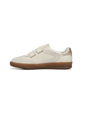 Beige sneakers with double Velcro straps, suede and smooth leather materials, rounded toe, and textured brown rubber sole. Gold accent on heel.