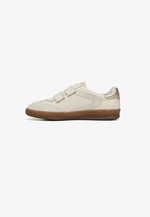 Beige sneakers with double Velcro straps, suede and smooth leather materials, rounded toe, and textured brown rubber sole. Gold accent on heel.