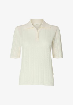 Krémové krátké pletené polo tričko s jemným vertikálním krajkovým vzorem, límečkem a zapínáním na knoflíky u výstřihu.