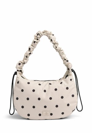 Cremefarvet skuldertaske med sorte prikker, samlet stofhåndtag og en lynlåslukning med et lille logo-patch på forsiden.