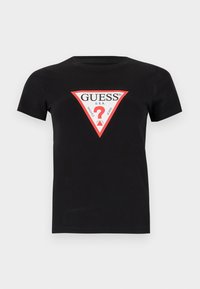 T-shirt en coton noir avec un logo triangulaire rouge et blanc portant le texte "GUESS U.S.A." et un point d'interrogation au centre. Manches courtes.