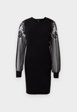 Black dress with a round neckline and long, sheer striped sleeves featuring floral lace accents. Fitted body, knee-length hem.