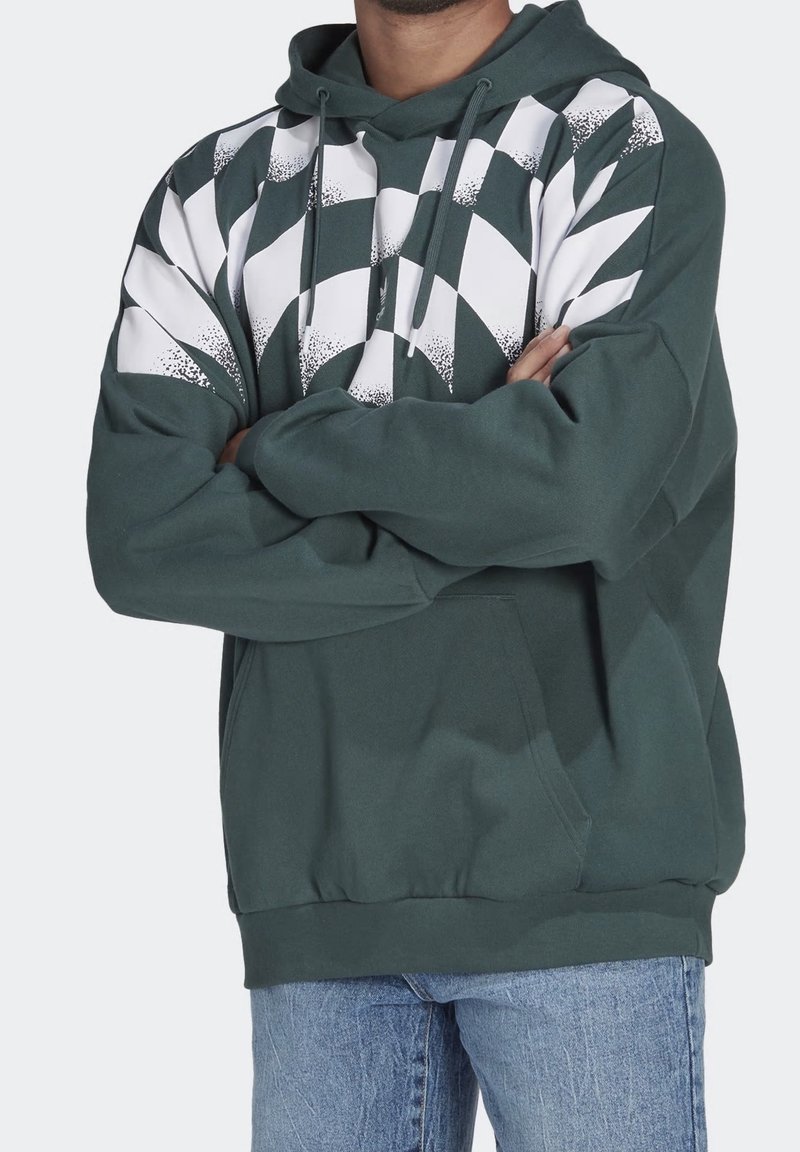 Zelená mikina s kapucí a bílým vzorovaným designem na jedné straně, má přední kapsu a stahovací kapuci. Měkká látka s volným střihem.
