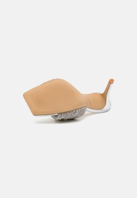 Sandale à talons au design étroit, dotée d'une tige en textile argenté, d'une semelle en caoutchouc beige et d'un talon flexible. Semelle texturée pour une meilleure adhérence.