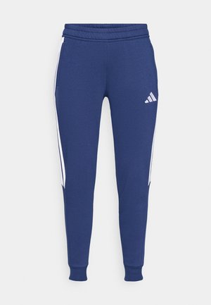 Navy blue sweatpants with an elastic waistband, white side stripes, and a printed logo on the left thigh. Soft, textured fabric.
