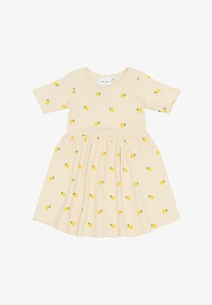 Abito giallo a fantasia di limoni in tessuto beige a coste, maniche corte, scollo rotondo e gonna a ruota. Morbido al tatto con accenti giocosi.