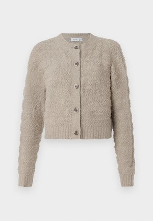 Cardigan beige texturé avec un col rond, une fermeture à boutons sur le devant et un ourlet côtelé. Dispose d'un tissu confortable et pelucheux ainsi que de longues manches.