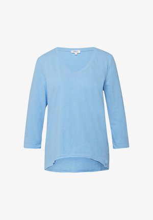 Helehall sinine naiste pikkade varrukatega V-kaelusega särk, mille alumine serv on veidi kaarduv ja esiküljel vasakul all on väike kangasilt.