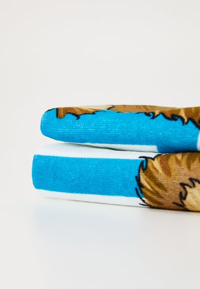 Fleece blanket folded, featuring a blue background with a brown animal design. Soft texture with a smooth white edge.