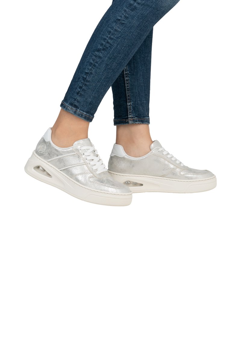 Silver metallic sneakers with a smooth finish, white accents, and lace-up design. Features air cushioning in the sole for comfort.