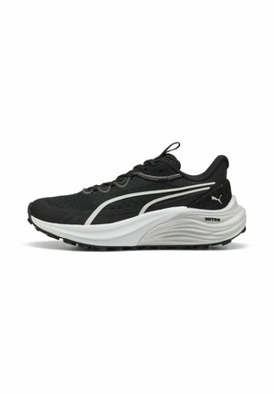 Schwarzer Sportschuh mit einem Mesh-Obermaterial und weißen Akzenten. Verfügt über eine dicke weiße Sohle und ein strukturiertes schwarzes Profil für besseren Halt. Schnürsenkel und eine Zugschlaufe sind enthalten.