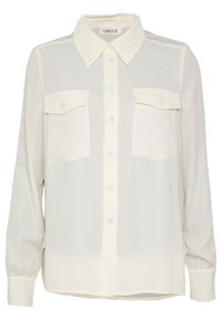 Blouse couleur crème avec fermeture à boutons sur le devant, col classique et deux poches poitrine. Fabriquée en tissu léger avec des manches longues.