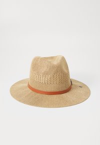 Sombrero de paja con ala ancha y textura trenzada; cuenta con una banda de cuero marrón alrededor de la base y un pequeño adorno metálico.