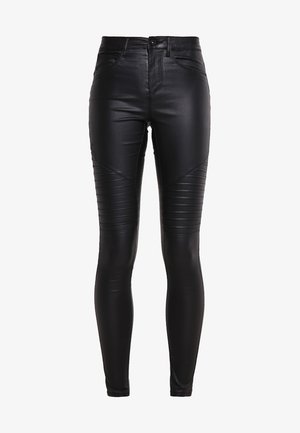 Mustade kunstnahk skinny püksid, millel on õmblustega paneelid, kõrge talje ja sile tekstuur. Omab lukkudega avamist ja ees olevaid taskuid.