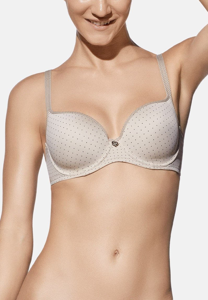 Sostén acolchado beige con estampado de lunares, tirantes ajustables y un acento en forma de corazón en el centro. Textura suave y soporte con aros.