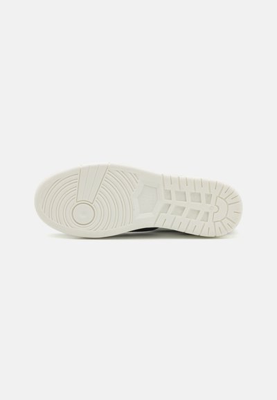 Shoe sole with a textured white rubber material, featuring circular and linear patterns for traction. Flat design with even thickness.