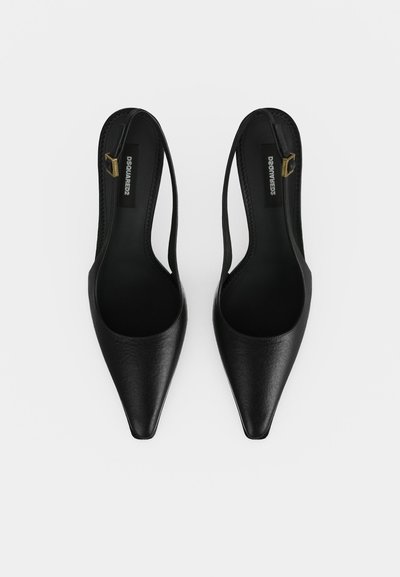 Pair of black leather pointed-toe slingback flats with thin ankle straps and gold buckle detail, viewed from above on white background.
