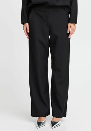 Pantaloni neri a gamba larga con una texture liscia, caratterizzati da un design sartoriale, una cintura elastica e senza tasche visibili.