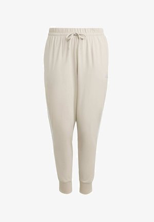 Beżowe spodnie dresowe wykonane z miękkiego materiału, z elastycznym paskiem w talii wyposażonym w sznurek do regulacji, ściągaczami przy nogawkach oraz bocznymi paskami.